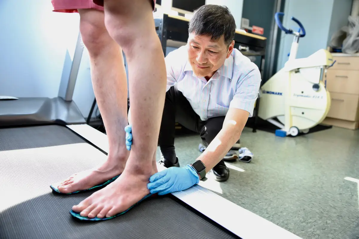 Podiatrist examining a patient's foot and ankle